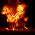 burning man attendee jump into fire