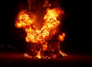 burning man attendee jump into fire