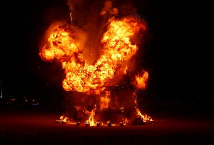 burning man attendee jump into fire